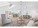 Bright open-concept area with hardwood floors, a modern kitchen, dining area, and comfortable living room furniture at 5120 3Rd N Ave, St Petersburg, FL 33710