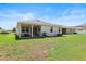 Spacious backyard with covered patio, grill and views of surrounding neighborhood at 520 Valri Park Dr, Valrico, FL 33594