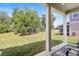 Spacious backyard is viewed from a covered patio with ceiling fan at 520 Valri Park Dr, Valrico, FL 33594