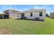 Green backyard with a covered patio and grill offers space for outdoor activities and relaxation at 520 Valri Park Dr, Valrico, FL 33594