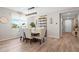 Elegant dining area with stylish furnishings, wood-look flooring, and a modern chandelier at 520 Valri Park Dr, Valrico, FL 33594