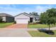Charming single-story home with landscaped yard, a two-car garage and brick driveway at 520 Valri Park Dr, Valrico, FL 33594