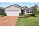 Charming single-story home featuring a brick driveway, well-manicured lawn, and delightful landscaping at 520 Valri Park Dr, Valrico, FL 33594