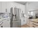 Bright kitchen featuring stainless refrigerator and sleek white cabinets at 520 Valri Park Dr, Valrico, FL 33594