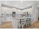 Stylish kitchen island features white cabinets, granite countertop, and seating for three at 520 Valri Park Dr, Valrico, FL 33594