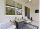 Relaxing covered patio features modern furniture, ceiling fan and a view of the backyard at 520 Valri Park Dr, Valrico, FL 33594