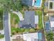 Aerial view showcasing solar panels, driveway, and meticulously landscaped yard at 5215 Denver Ne St, St Petersburg, FL 33703