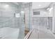 Renovated bathroom highlighting a modern glass shower, free-standing tub, and textured wall tile at 5215 Denver Ne St, St Petersburg, FL 33703