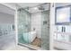Modern bathroom renovation featuring a freestanding tub, glass shower, and textured tile at 5215 Denver Ne St, St Petersburg, FL 33703