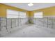 Bedroom featuring yellow walls and two windows, awaiting renovation to become a cozy, personalized space at 5215 Denver Ne St, St Petersburg, FL 33703