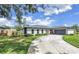 Charming single-story home with a well-manicured lawn and a spacious driveway at 5215 Denver Ne St, St Petersburg, FL 33703