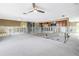 Open-concept living room and kitchen gutted for renovation, with updated ceiling fan and cabinets at 5215 Denver Ne St, St Petersburg, FL 33703