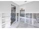 Partially renovated room with exposed studs, doorway and gray paint, providing opportunity for customization at 5215 Denver Ne St, St Petersburg, FL 33703