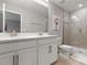 Bright bathroom with double vanity, tiled shower with glass door, and neutral color scheme at 5270 Neil Dr, St Petersburg, FL 33714