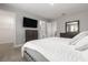 Bedroom featuring neutral walls, carpet, queen bed, dresser, closet and bathroom access at 5270 Neil Dr, St Petersburg, FL 33714