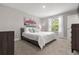 Cozy bedroom with neutral walls, carpet, a queen sized bed, and ample natural light at 5270 Neil Dr, St Petersburg, FL 33714