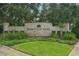 Beautifully landscaped community entrance with stone sign reading Heritage Oaks at 5270 Neil Dr, St Petersburg, FL 33714