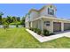 A townhouse featuring a well-maintained lawn and landscaping, showcasing curb appeal and outdoor space at 5270 Neil Dr, St Petersburg, FL 33714