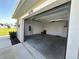 Spacious two-car garage with painted walls, concrete floor, and electric vehicle charger at 5270 Neil Dr, St Petersburg, FL 33714