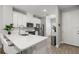 Modern kitchen with white cabinets, stainless steel appliances, and a breakfast bar with sleek countertops at 5270 Neil Dr, St Petersburg, FL 33714