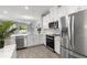Stylish kitchen with stainless steel appliances, white cabinetry, and open design for easy entertaining at 5270 Neil Dr, St Petersburg, FL 33714