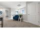 Cozy landing area featuring a blue armchair, neutral walls, and plush carpeting at 5270 Neil Dr, St Petersburg, FL 33714