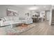Open-concept living area with stylish décor, including a sectional couch, rug, and easy kitchen access at 5270 Neil Dr, St Petersburg, FL 33714
