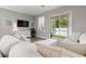 Comfortable living room featuring a plush sofa, sliding door to a screened lanai and serene views at 5270 Neil Dr, St Petersburg, FL 33714