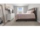 Main bedroom featuring carpet, a queen bed, dresser, television and natural light at 5270 Neil Dr, St Petersburg, FL 33714