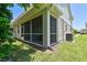 Relaxing screened-in patio extends the living space outdoors while offering a tranquil view of the yard at 5270 Neil Dr, St Petersburg, FL 33714