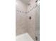 Tiled shower with glass door showcasing neutral tones and clean design at 5270 Neil Dr, St Petersburg, FL 33714