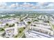 An aerial view shows multiple buildings with lush green landscaping, lakes, and parking lots at 5530 80Th N St # A306, St Petersburg, FL 33709