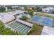 Aerial view of community amenities including a pool, shuffleboard and tennis courts at 5530 80Th N St # A306, St Petersburg, FL 33709
