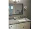 Bathroom vanity with gray granite countertops and vanity mirror at 5530 80Th N St # A306, St Petersburg, FL 33709