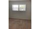 Bedroom with shuttered window and neutral carpet at 5530 80Th N St # A306, St Petersburg, FL 33709