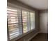 Bedroom featuring plantation shutters with outside neighborhood views at 5530 80Th N St # A306, St Petersburg, FL 33709