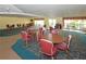 Large clubhouse area with tables, chairs, and natural light from the many windows at 5530 80Th N St # A306, St Petersburg, FL 33709