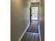 Long entryway featuring neutral walls and a door leading to an outside balcony at 5530 80Th N St # A306, St Petersburg, FL 33709