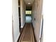 Entryway hallway showcasing a decorative rug, neutral walls and views to the living room at 5530 80Th N St # A306, St Petersburg, FL 33709