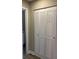 Hallway with a closet with louvered doors; view into the bathroom at 5530 80Th N St # A306, St Petersburg, FL 33709