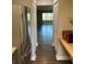 View into a bright living room from the kitchen showing the refrigerator and kitchenette at 5530 80Th N St # A306, St Petersburg, FL 33709