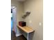 Kitchenette area with a built-in wood table, microwave and open shelves for storage and meal prep at 5530 80Th N St # A306, St Petersburg, FL 33709