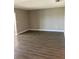Spacious living room features neutral walls and wood-look floors at 5530 80Th N St # A306, St Petersburg, FL 33709