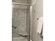 Modern shower featuring gray marble-look walls, glass doors, grab bar, and corner seat at 5530 80Th N St # A306, St Petersburg, FL 33709