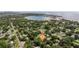 Aerial view of a residential area with mature trees and a lake in the background at 5901 3Rd S St, St Petersburg, FL 33705