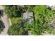 An aerial view of a home surrounded by trees, showing the roof and nearby streets at 5901 3Rd S St, St Petersburg, FL 33705