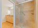 Bathroom features a tiled shower with glass door, seat, and adjacent double vanity at 5901 3Rd S St, St Petersburg, FL 33705
