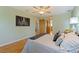 Light-filled bedroom with wood floors features stylish decor and a ceiling fan at 5901 3Rd S St, St Petersburg, FL 33705