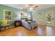 Cozy bedroom with wood floors, neutral walls, ceiling fan, and natural light at 5901 3Rd S St, St Petersburg, FL 33705