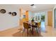 Open dining area with wood floors and view of the kitchen and lanai at 5901 3Rd S St, St Petersburg, FL 33705